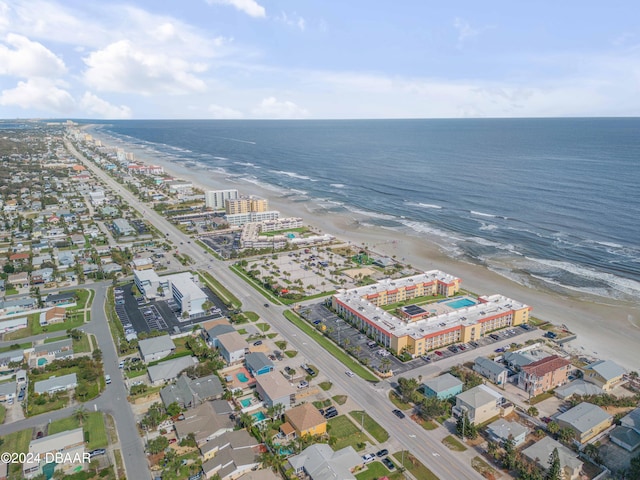 drone / aerial view featuring a beach view and a water view