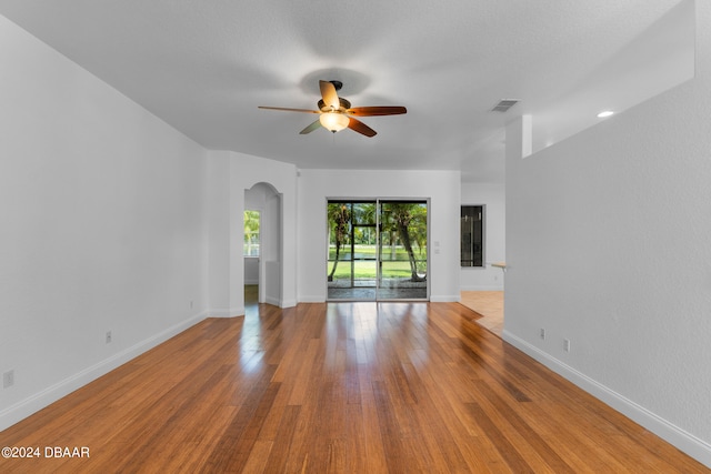 unfurnished living room with ceiling fan and light hardwood / wood-style floors