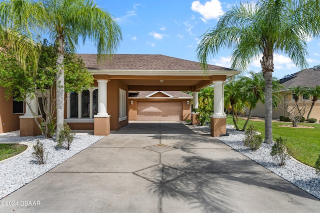 view of front of home with a garage, a front lawn, and a carport