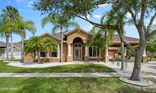 view of front of home with a garage and a front yard