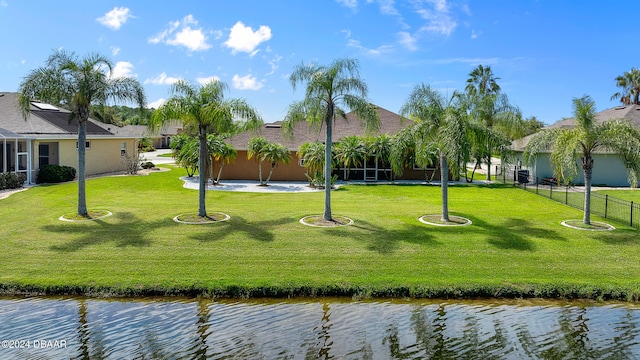 view of home's community with a yard and a water view