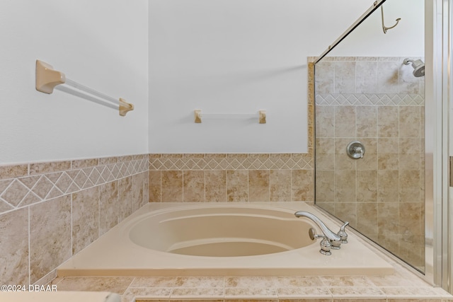 bathroom with a relaxing tiled tub