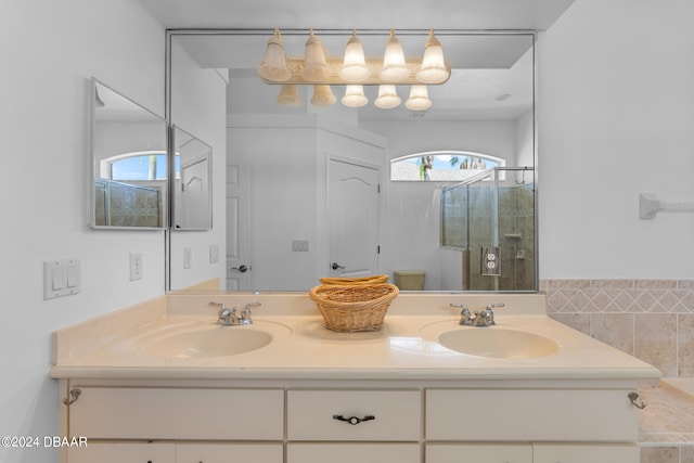 bathroom with vanity, toilet, and a shower with shower door