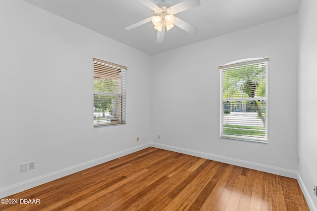 spare room featuring hardwood / wood-style flooring and ceiling fan