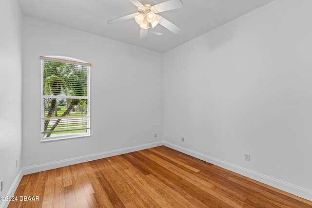 spare room featuring hardwood / wood-style floors and ceiling fan