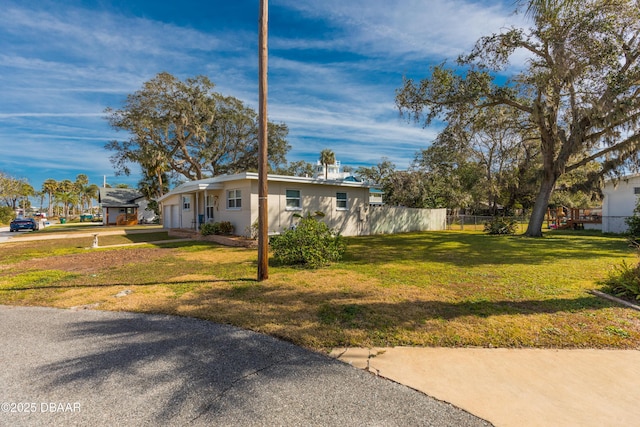 view of front facade with a garage and a front lawn