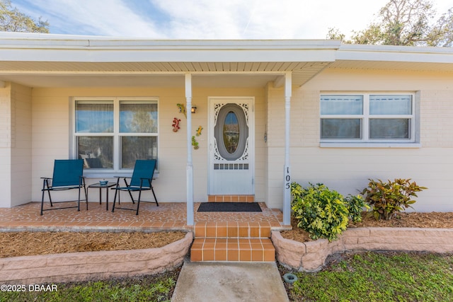 doorway to property featuring covered porch