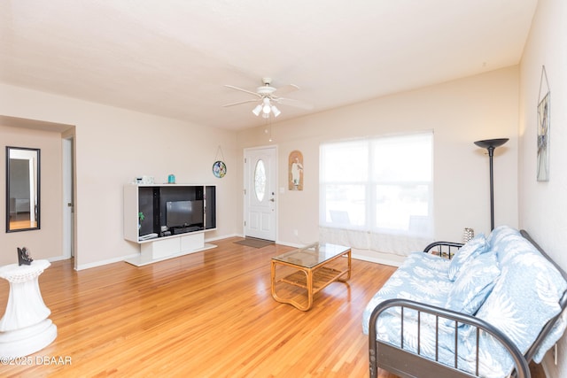 living room with hardwood / wood-style flooring and ceiling fan