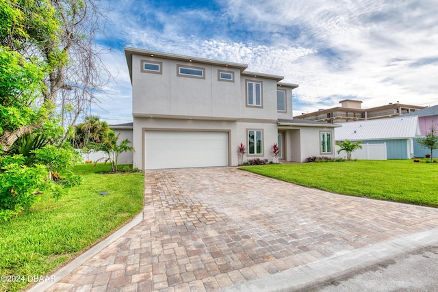 view of front of home featuring a front yard and a garage