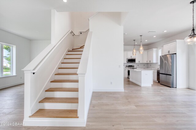 staircase with hardwood / wood-style flooring