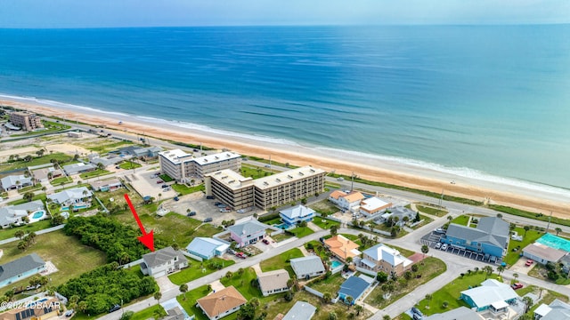 drone / aerial view featuring a view of the beach and a water view