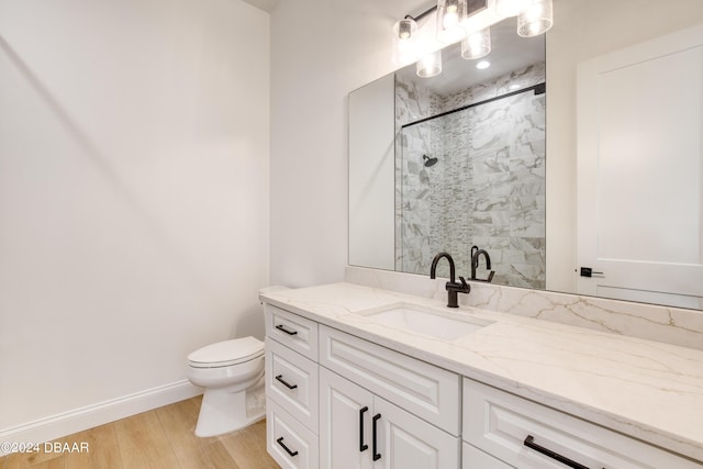 bathroom with wood-type flooring, vanity, toilet, and an enclosed shower