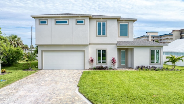 view of front facade with a front yard and a garage