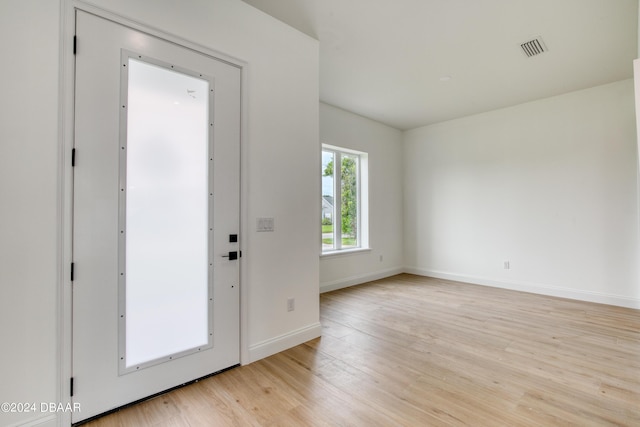 foyer entrance with light hardwood / wood-style floors