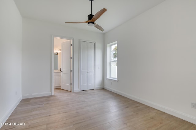 unfurnished bedroom with ensuite bathroom, light hardwood / wood-style flooring, and ceiling fan