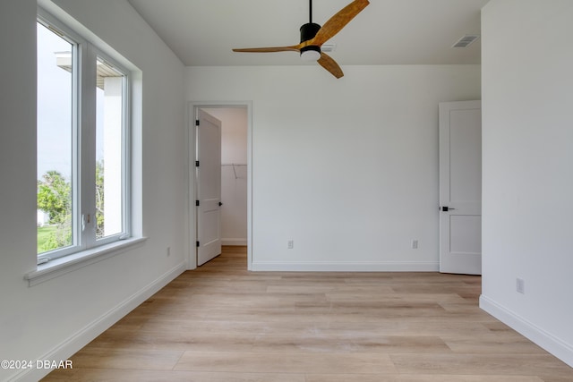 spare room with light hardwood / wood-style floors and ceiling fan