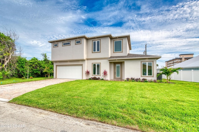 view of front of home with a garage and a front lawn