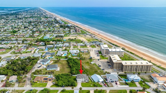 birds eye view of property with a water view and a view of the beach