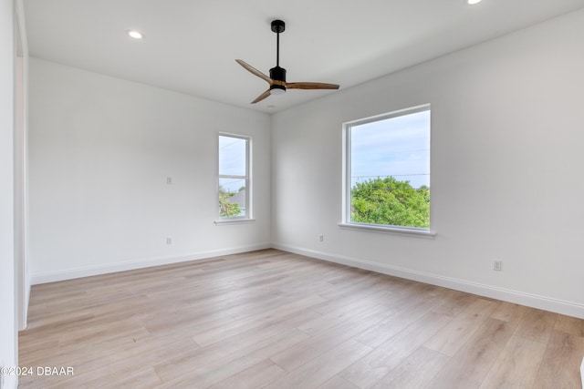 unfurnished room featuring plenty of natural light, light hardwood / wood-style floors, and ceiling fan