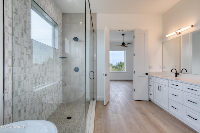 bathroom with hardwood / wood-style floors, ceiling fan, vanity, and independent shower and bath