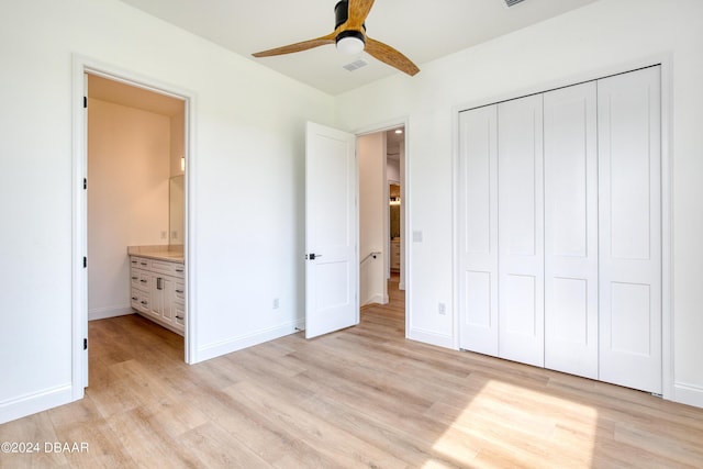 unfurnished bedroom with a closet, light hardwood / wood-style floors, and ceiling fan