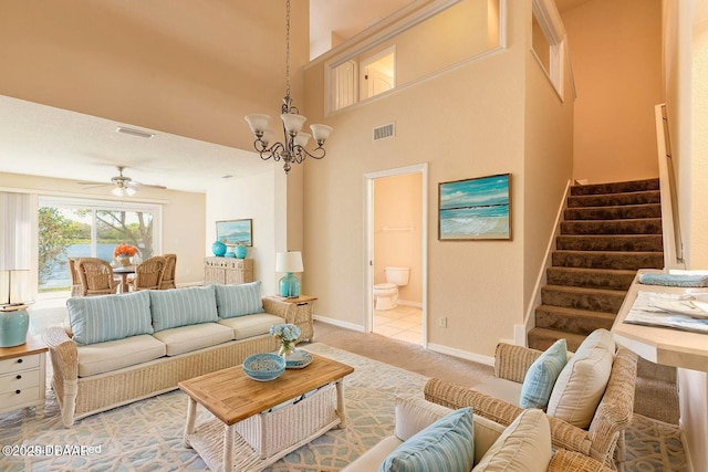1003 Alabama Ave, Holly Hill, FL 32117 - living room featuring stairway, a chandelier, light carpet, a ceiling fan, and baseboards