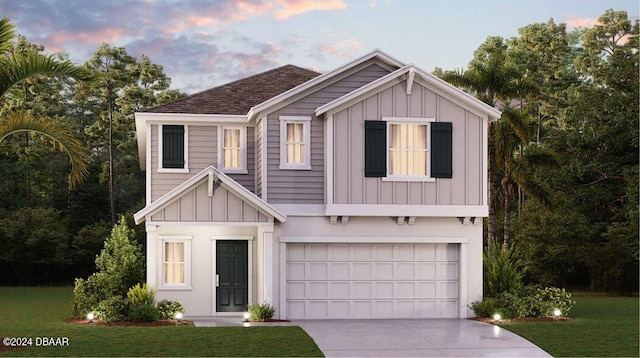 view of front of house featuring a yard and a garage