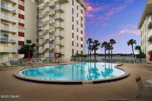 2711 N Halifax Ave Unit 372, Daytona Beach, FL 32118 - pool at dusk with a community pool and a patio area