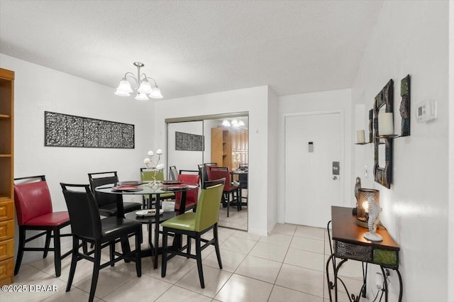 2711 N Halifax Ave Unit 372, Daytona Beach, FL 32118 - dining space with a chandelier, light tile patterned floors, and a textured ceiling