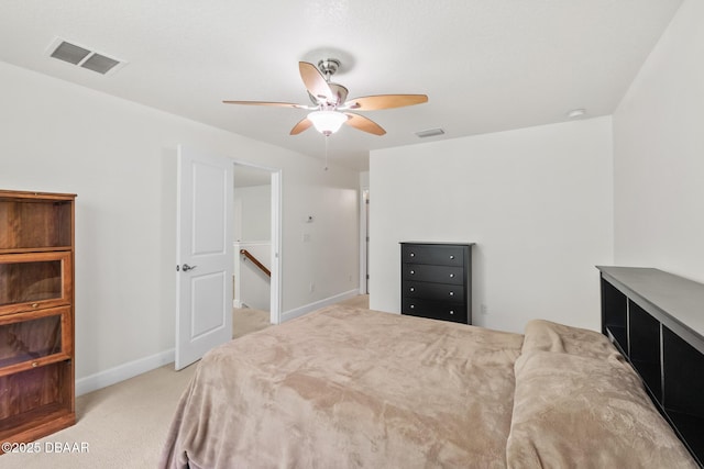 carpeted bedroom with visible vents, baseboards, and ceiling fan