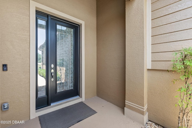 doorway to property with stucco siding