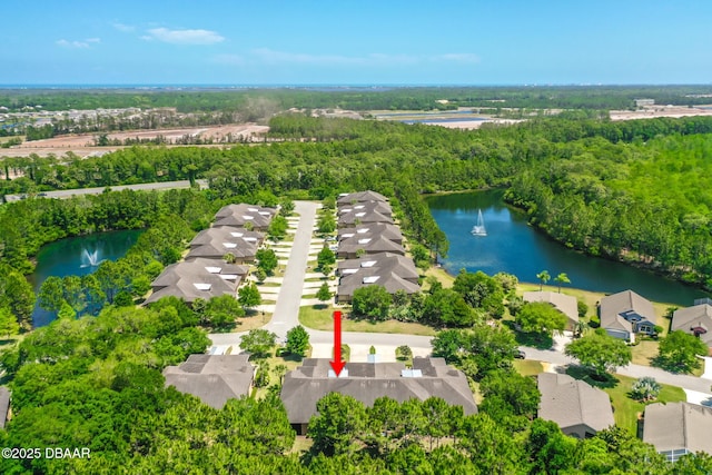 drone / aerial view featuring a residential view and a water view