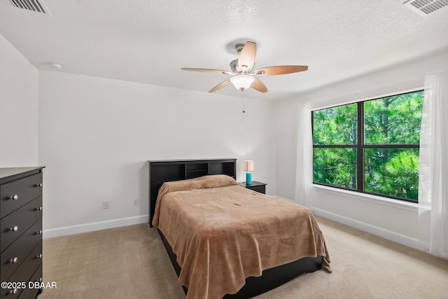 bedroom featuring visible vents, light colored carpet, and baseboards