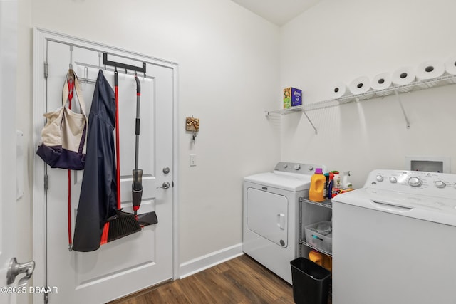 laundry area featuring washer and dryer, baseboards, dark wood-style flooring, and laundry area