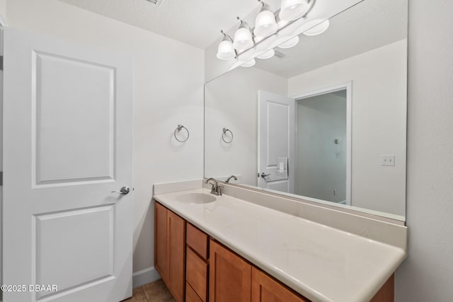 bathroom featuring tile patterned floors, a notable chandelier, and vanity