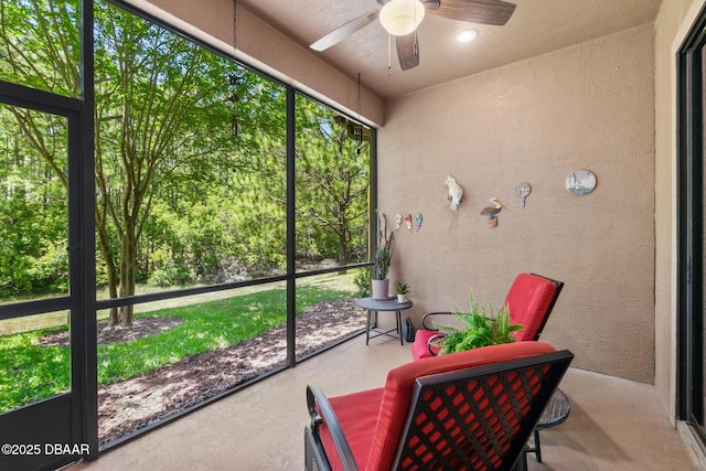 sunroom featuring a ceiling fan