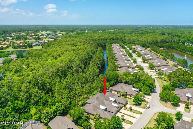 aerial view featuring a residential view, a water view, and a wooded view