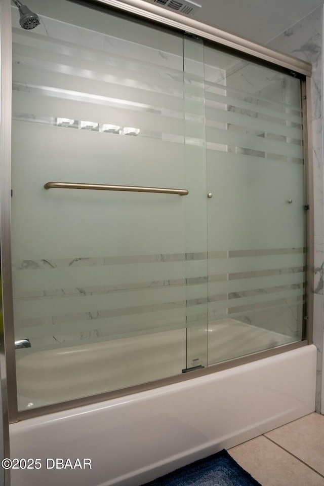 bathroom with tile patterned floors and combined bath / shower with glass door