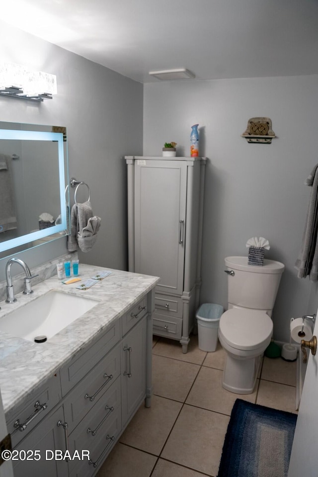 bathroom featuring tile patterned flooring, vanity, and toilet