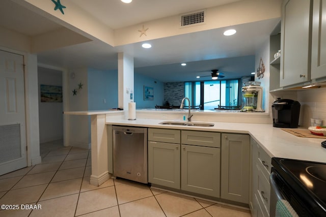 kitchen featuring dishwasher, sink, gray cabinetry, backsplash, and kitchen peninsula