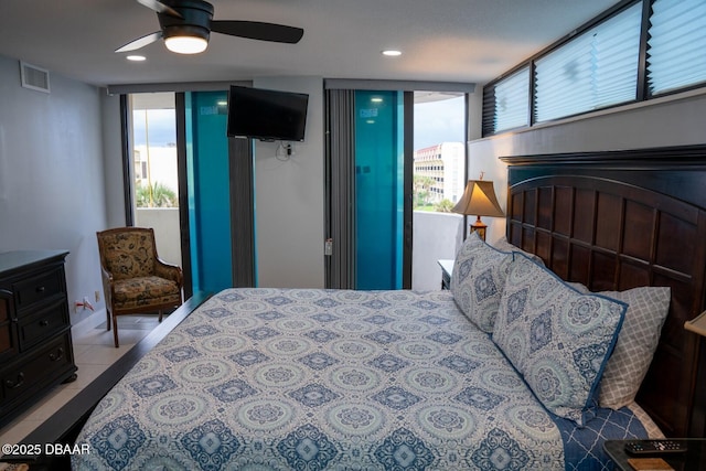 tiled bedroom with multiple windows and ceiling fan