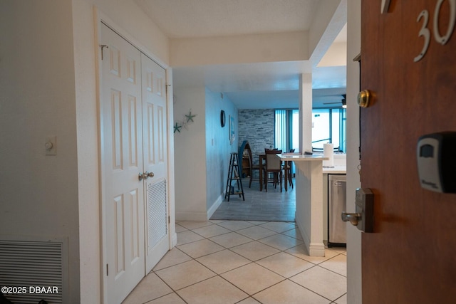 corridor featuring light tile patterned floors