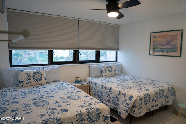 bedroom featuring light tile patterned floors and ceiling fan