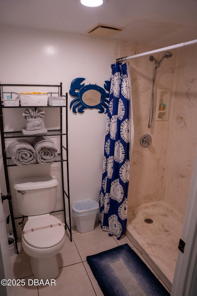 bathroom with tile patterned floors, toilet, and a shower with shower curtain