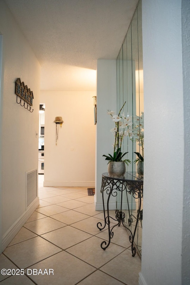 hall with light tile patterned flooring