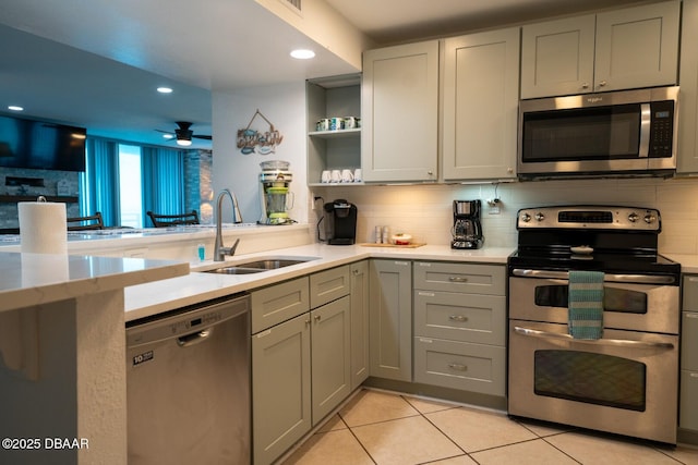 kitchen with gray cabinets, tasteful backsplash, appliances with stainless steel finishes, and sink