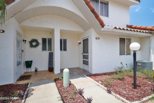 property entrance featuring central AC unit