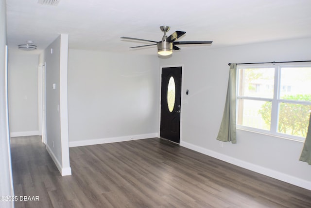 foyer entrance with a ceiling fan, baseboards, and dark wood-type flooring