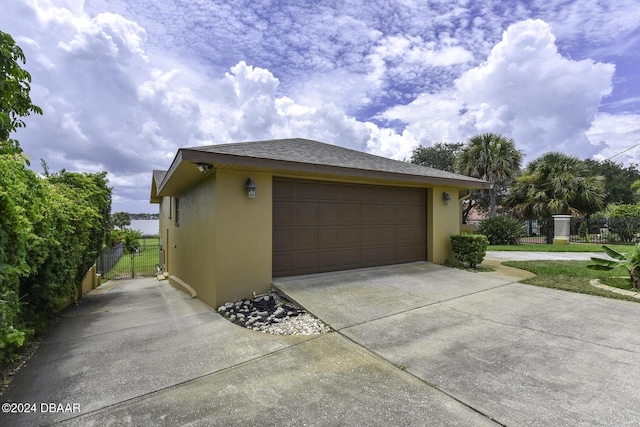 1199 N Halifax Ave, Daytona Beach, FL 32118 - view of side of property featuring stucco siding and a detached garage