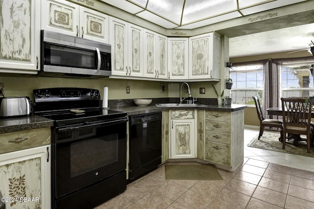 1199 N Halifax Ave, Daytona Beach, FL 32118 - kitchen with black appliances, dark countertops, ceiling fan, and light tile patterned floors